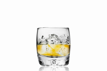 Whiskey glass isolated on white background. Ice is a little bit blurred on the second plan.