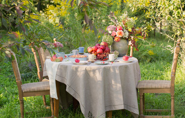 apple pie on laid table in  garden on sunny day