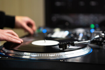 Dj scratching vinyl records on turn table. Professional hip hop disc jockey mixing musical tracks...