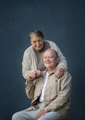 happy elderly married couple on blue background