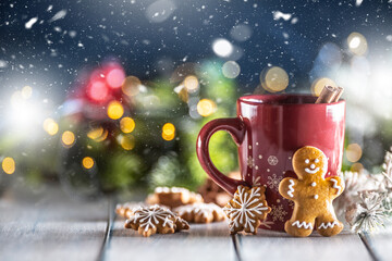 Christmas punch in a red cup with gingerbread cinnamon and holiday decorations