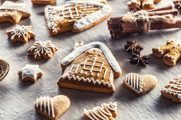 House with gingerbread and other Christmas cookies along with cinnamon and pine cones