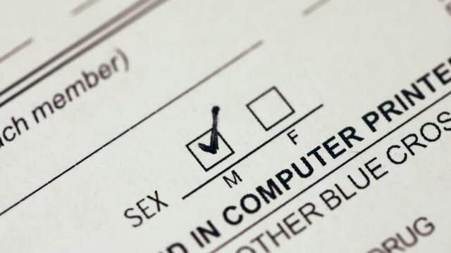 Person marking gender checkbox in a form