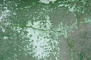 A concrete wall with remnants of green paint .Background