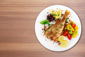 Traditional food tasty fish with vegetables on a plate