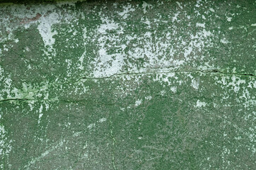 A concrete wall with remnants of green paint .Background
