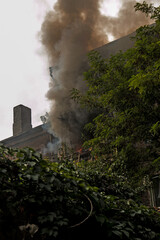 Fire on the balcony of a five-story building. Fire and black clouds of smoke. Smoke in the...