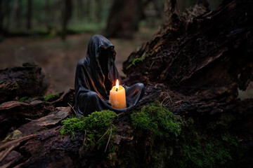 Magic candlestick with burning candle in mysterios dark forest. pagan, Wiccan, Slavic traditions. esoteric spiritual ritual for Samhain sabbat or Halloween - obrazy, fototapety, plakaty