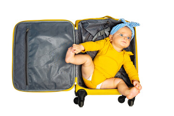 Baby girl lay in empty travel hand luggage suit