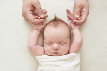 Newborn baby boy in daddy's hands sleeping on white background. Medicine and health concept, happy motherhood and fatherhood. Maternity hospital and clinic. Father and mother day