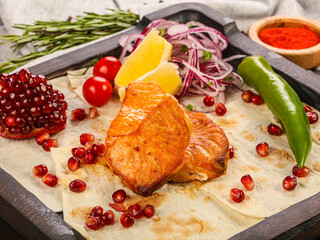 Grilled salmon steaks served lemon