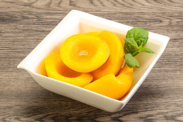 Sweet ripe canned peaches with mint