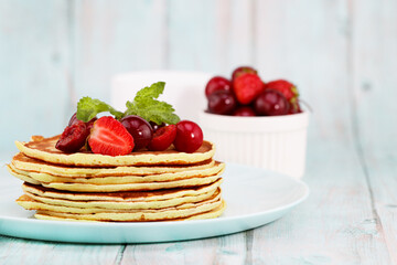 homemade pancakes and fresh berries. Pancakes with strawberries and cherries