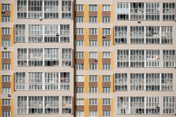 Fototapeta na wymiar Windows on the facades of high-rise apartment buildings, close-up