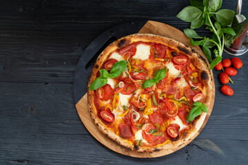 Pizza with salami and tomatoes