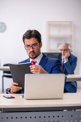 Two male colleagues working in the office