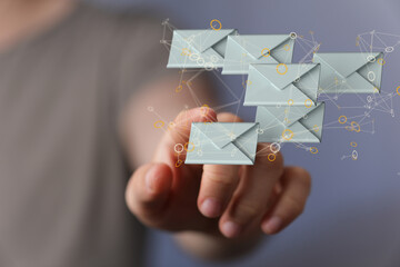 Hand holding using mobile phone with email icon on screen. Concept of business communication