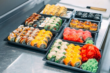 Sushi delivery. Many varieties of Sushi in a plastic box are prepared for delivery.