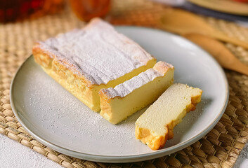 Homemade cottage cheese casserole sprinkled with powdered sugar.