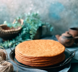 Cooking honey cake at home. Round baked cake layers stacked on plate.