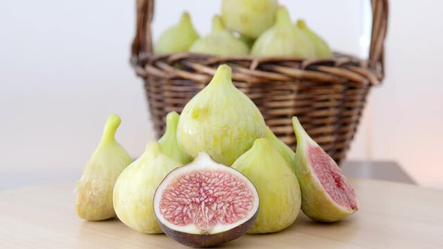 Green Figs Rotating. This video captures a few of figs  rotating and full of basket behind the scene.