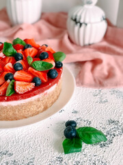 Yogurt cake with strawberries, blueberries and mint.