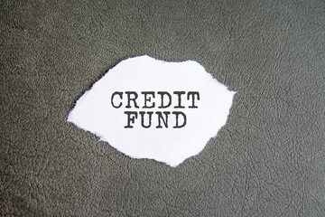 credit fund sign on the torn paper on the gray background
