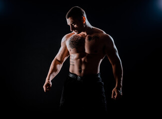 Muscular man during workout in the gym