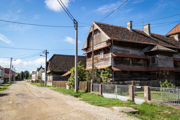 Fototapeta na wymiar Old, traditional wooden school in the village of Kuce, on the edge of Turopolje forest, monument of traditional croatian architecture in continental regions
