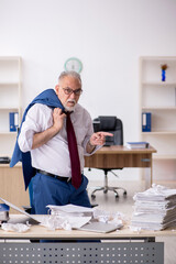 Old male employee unhappy with excessive work in the office