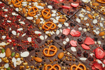 Handmade chocolate bars with a variety of dried fruit and nut toppings.