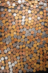 Coins, Brazilian coins of various values ​​spread over a black leather surface, top view.