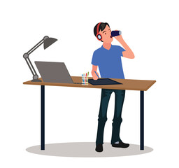 A male programmer works with digital technologies and drinks lemonade in the kitchen.