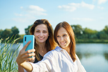 Women friend enjoying activities in nature take selfie