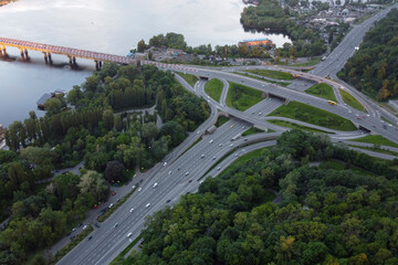 Fototapeta premium View of the road in the green city - Kiev. The photo shows the bridge