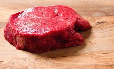 One juicy fillet steak on a wooden table surface. Butcher craft. Meat industry product. Finest range of meat.