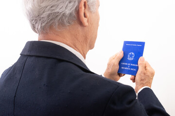 elderly man holding Brazilian social security and work permit