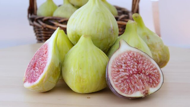 Green Figs Rotating. This video captures a few of figs  rotating and full of basket behind the scene.