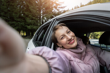 Portrait of young adult beautiful caucasian woman driver enjoy roadtrip adventure traveling by car...