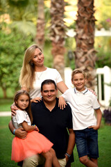 Fototapeta premium A happy family with kids in the park