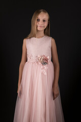 Fototapeta premium Little beautiful and cute girl child in a fashionable festive dress 