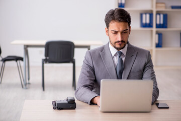 Young male employee and too much work in the office