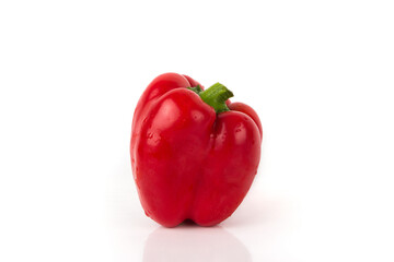 Red raw bell pepper on the white glossy background