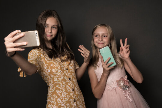 Two girl take a selfie on a smartphone