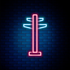 Glowing neon line Electric tower used to support an overhead power line icon isolated on brick wall background. High voltage power pole line. Colorful outline concept. Vector