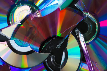 Stack of broken CD and DVD discs. Data destruction background. Damaged CD, DVD compact discs