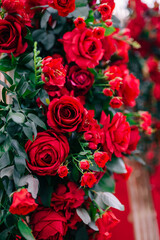 Luxurious decoration of a wedding table in a restaurant. Bush Fresh beautiful red roses.