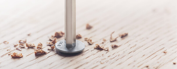 hex bolt screw by hex wrench  in wooden oaks plate. Spanner, bolt, screw and nuts.