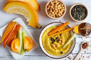 Homemade hummus from chickpeas and pumpkin with vegetables. Autumn Pumpkin Snacks. Vegetarian cooking