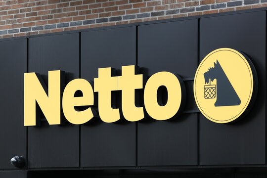 Horsens, Denmark - May 13, 2021: Netto sign on a wall. Netto is a Danish discount supermarket operating in several European countries. Netto is owned by Danish Supermarket Group